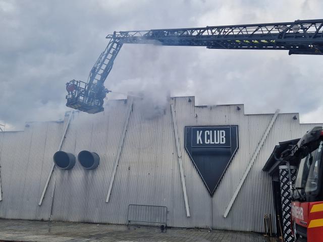 This picture shows a firetruck and firemen working at the site of a fire accident at the nightclub K in Kehl, south-western Germany, on March 29, 2026. Hundreds of people were evacuated from a nightclub in southwest Germany after a fire broke out, police said on March 29, 2026, with images from the scene showing the blaze raging on the building's roof. (Photo by NonStopNews / AFP)