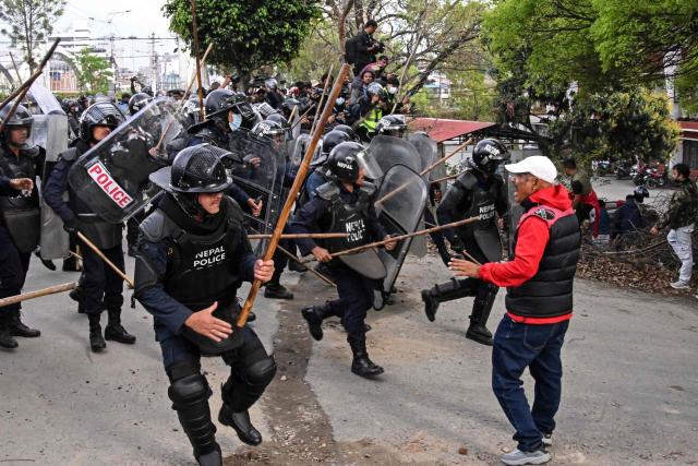 Police personnel clash with supporters of Nepal's former prime minister Khadga Prasad Sharma Oli, during a protest against his arrest in Kathmandu on March 29, 2026. A Nepal court on March 29 extended by five days the detention of Oli and his home minister after their arrest over alleged involvement in a deadly crackdown on the 2025 protests that ousted him. (Photo by Prakash MATHEMA / AFP)
