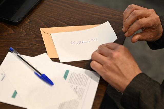 A voter prepares his ballot for the nomination vote of the newly elected mayor during the inaugural city council session at the city hall of Aubervilliers on March 29, 2026. (Photo by Blanca CRUZ / AFP)