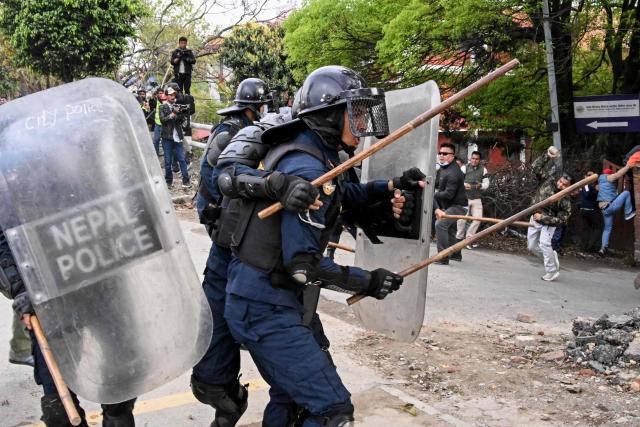 Police personnel clash with supporters of Nepal's former prime minister Khadga Prasad Sharma Oli, during a protest against his arrest in Kathmandu on March 29, 2026. A Nepal court on March 29 extended by five days the detention of Oli and his home minister after their arrest over alleged involvement in a deadly crackdown on the 2025 protests that ousted him. (Photo by Prakash MATHEMA / AFP)