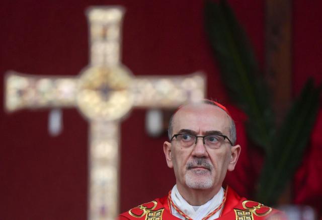 Latin Patriarch of Jerusalem, Cardinal Pierbattista Pizzaballa, leads a prayer service to mark Palm Sunday in Jerusalem on March 29, 2026, following the cancellation of the traditional Palm Sunday procession from the Mount of Olives amid restrictions on gathering in large groups and the US-Israeli war on Iran. Israeli authorities have cancelled the Palm Sunday procession in Jerusalem due to wartime restrictions. Israel has been at war since it and the US launched strikes against Iran on February 28, sparking swift retaliation by the Islamic republic which responded with missile attacks across the region. (Photo by Ammar Awad / POOL / AFP)
