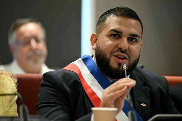 Aubervilliers' newly elected mayor Sofienne Karroumi, wearing his tricolour mayoral sash, gives a speech after being nominated during the inaugural city council session at the city hall of Aubervilliers on March 29, 2026. (Photo by Blanca CRUZ / AFP)