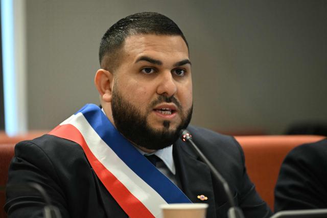 Aubervilliers' newly elected mayor Sofienne Karroumi, wearing his tricolour mayoral sash, gives a speech after being nominated during the inaugural city council session at the city hall of Aubervilliers on March 29, 2026. (Photo by Blanca CRUZ / AFP)