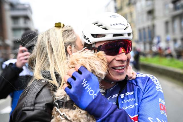 Belgian Jasper Philipsen and his partner Melanie Peetermans celebrate after winning the men elite 'Middelkerke-Wevelgem - In Flanders Fields' one day cycling race, 240.8 km from Middelkerke to Wevelgem, on March 29, 2026. (Photo by JASPER JACOBS / Belga / AFP) / Belgium OUT