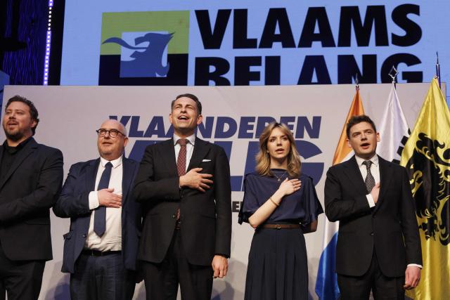 Belgian senator Bob De Brabandere (L), Vlaams Belang's MP Ortwin Depoortere, Vlaams Belang chairman Tom Van Grieken, Vlaams Belang's politician Mercina Claesen and Vlaams Belang's MP Alexander Van Hoecke stand on stage during the 'Vlaanderen Veilig' (Flanders Safe) meeting of Flemish far-right party Vlaams Belang (VB), in Brussels on March 29, 2026. (Photo by NICOLAS MAETERLINCK / Belga / AFP) / Belgium OUT