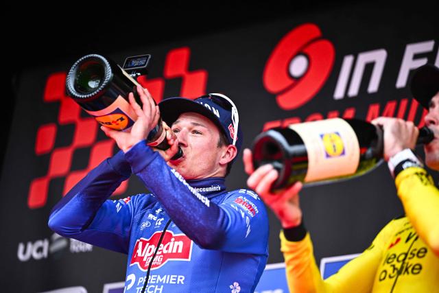 Belgian Jasper Philipsen of Alpecin-Premier Tech celebrates on the podium after winning the men elite 'Middelkerke-Wevelgem - In Flanders Fields' one day cycling race, 240.8 km from Middelkerke to Wevelgem, on March 29, 2026. (Photo by JASPER JACOBS / Belga / AFP) / Belgium OUT