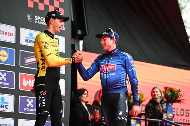 Belgian Jasper Philipsen of Alpecin-Premier Tech (R) shakes hand of French Christophe Laporte of Team Visma-Lease a Bike on the podium after the men’s elite “Middelkerke–Wevelgem – In Flanders Fields” one-day cycling race, covering 240.8 km from Middelkerke to Wevelgem, on March 29, 2026. (Photo by ELIAS ROM / Belga / AFP) / Belgium OUT