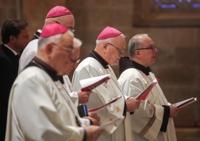 Members of the clergy attend a prayer service in the Church of All Nations held by Latin Patriarch of Jerusalem, Cardinal Pierbattista Pizzaballa, to mark Palm Sunday in Jerusalem on March 29, 2026, following the cancellation of the traditional Palm Sunday procession from the Mount of Olives amid restrictions on gathering in large groups and the US-Israeli war on Iran. Israeli authorities have cancelled the Palm Sunday procession in Jerusalem due to wartime restrictions. Israel has been at war since it and the US launched strikes against Iran on February 28, sparking swift retaliation by the Islamic republic which responded with missile attacks across the region. (Photo by Ammar Awad / POOL / AFP)