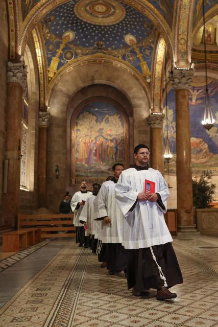 Members of the clergy walk on the day of a prayer service in the Church of All Nations held by Latin Patriarch of Jerusalem, Cardinal Pierbattista Pizzaballa, to mark Palm Sunday in Jerusalem on March 29, 2026, following the cancellation of the traditional Palm Sunday procession from the Mount of Olives amid restrictions on gathering in large groups and the US-Israeli war on Iran. Israeli authorities have cancelled the Palm Sunday procession in Jerusalem due to wartime restrictions. Israel has been at war since it and the US launched strikes against Iran on February 28, sparking swift retaliation by the Islamic republic which responded with missile attacks across the region. (Photo by Ammar Awad / POOL / AFP)