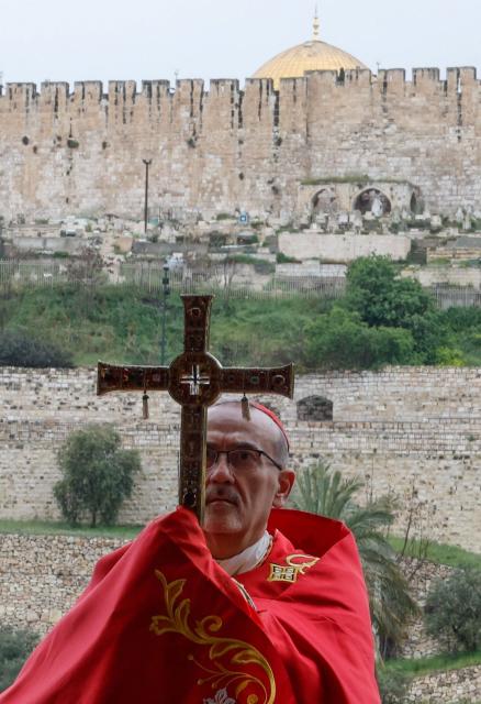 Latin Patriarch of Jerusalem, Cardinal Pierbattista Pizzaballa, leads a prayer service to mark Palm Sunday in Jerusalem on March 29, 2026, following the cancellation of the traditional Palm Sunday procession from the Mount of Olives amid restrictions on gathering in large groups and the US-Israeli war on Iran. Israeli authorities have cancelled the Palm Sunday procession in Jerusalem due to wartime restrictions. Israel has been at war since it and the US launched strikes against Iran on February 28, sparking swift retaliation by the Islamic republic which responded with missile attacks across the region. (Photo by Ammar Awad / POOL / AFP)