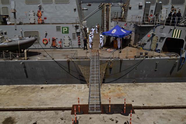 Crew members stand on the deck of the US Navy Arleigh Burke-class guided-missile destroyer USS Gridley (DDG 101), docked at the Amador cruise terminal in Panama City on March 29, 2026. The ship reached the country alongside the aircraft carrier USS Nimitz as part of the multinational maritime cooperation exercises “Mares del Sur 2026.” (Photo by MARTIN BERNETTI / AFP)