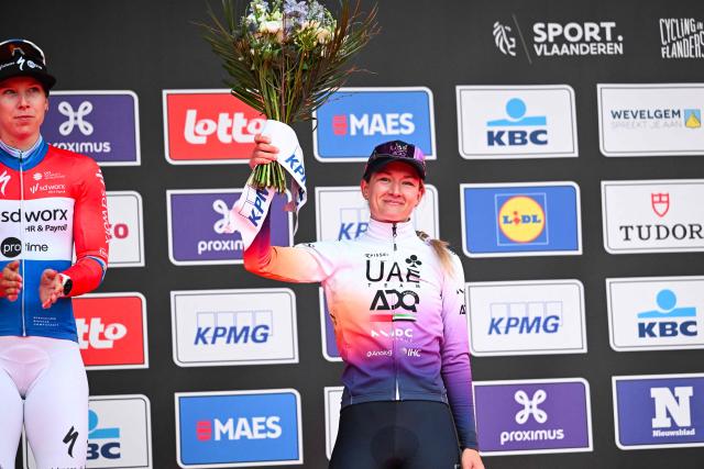Dutch Karlijn Swinkels of UAE Team ADQ holds up her bouquet of flowers on the podium after the women elite 'Wevelgem to Wevelgem - In Flanders Fields' one day cycling race, 134.9 km from and to Wevelgem, on March 29, 2026. (Photo by MAARTEN STRAETEMANS / Belga / AFP) / Belgium OUT