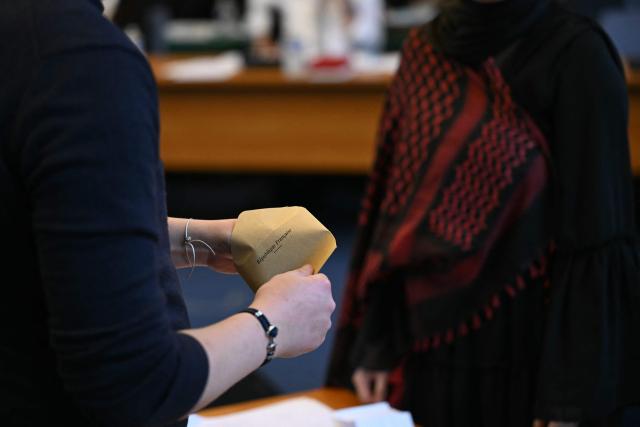 An attendee counts ballots during the inaugural city council session at the city hall of Le Blanc-Mesnil, on the outskirts of Paris, on March 29, 2026. (Photo by Blanca CRUZ / AFP)
