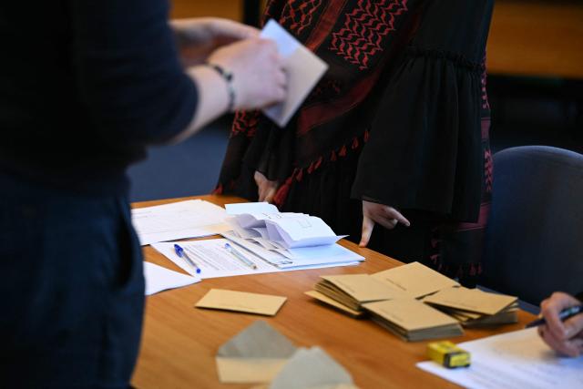 An attendee counts ballots during the inaugural city council session at the city hall of Le Blanc-Mesnil, on the outskirts of Paris, on March 29, 2026. (Photo by Blanca CRUZ / AFP)