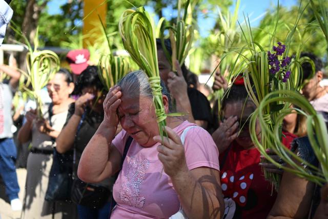 Catholic faithful participate in the Palm Sunday celebration at the beginning of Holy Week in Suchitoto, El Salvador, on March 29, 2026. (Photo by Marvin RECINOS / AFP)