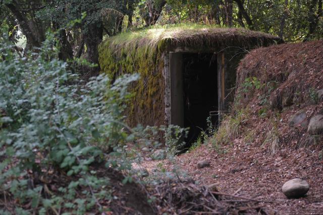 (FILES) View of the entrance of one of the bunkers used by cult leader former Wehmacht soldier Paul Schaefer in Colonia Dignidad (Dignity Colony), now called Villa Baviera, near Parral, Maule Province, Chile on April 15, 2025. Chile's new right-wing government will reverse plans to expropriate Colonia Dignidad, a German-themed settlement that served as a torture center when Augusto Pinochet was in power, a government minister said on March 29, 2026. The place featured a swimming pool, manicured lawns, and lush forest backdrop, making it look like a nice holiday getaway spot. (Photo by RODRIGO ARANGUA / AFP)