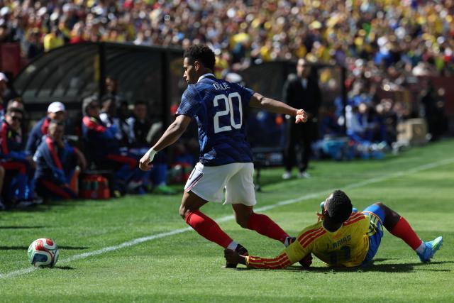 France's forward #20 Desire Doue is fouled by Colombia's defender #11 Johan Arias during a friendly football match between Colombia and France at Northwest Stadium in Landover, Maryland, on March 29, 2026. (Photo by FRANCK FIFE / AFP)