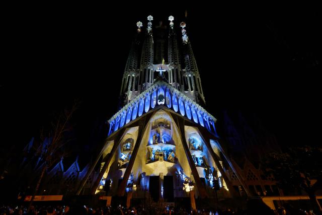 Lights illuminate the Passion facade (western side) of the Sagrada Familia basilica, during a music and light show narrating the passion and death of Jesus Christ, in Barcelona, on March 29, 2026, marking the start of the Holy Week. (Photo by Lluis GENE / AFP)