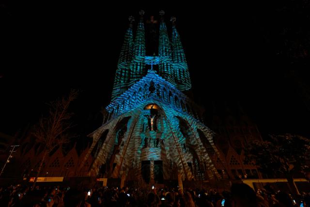 Lights illuminate the Passion facade (western side) of the Sagrada Familia basilica, during a music and light show narrating the passion and death of Jesus Christ, in Barcelona, on March 29, 2026, marking the start of the Holy Week. (Photo by Lluis GENE / AFP)