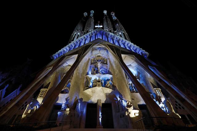 Lights illuminate the Passion facade (western side) of the Sagrada Familia basilica, during a music and light show narrating the passion and death of Jesus Christ, in Barcelona, on March 29, 2026, marking the start of the Holy Week. (Photo by Lluis GENE / AFP)