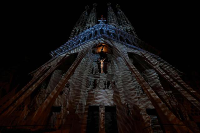 Lights illuminate the Passion facade (western side) of the Sagrada Familia basilica, during a music and light show narrating the passion and death of Jesus Christ, in Barcelona, on March 29, 2026, marking the start of the Holy Week. (Photo by Lluis GENE / AFP)
