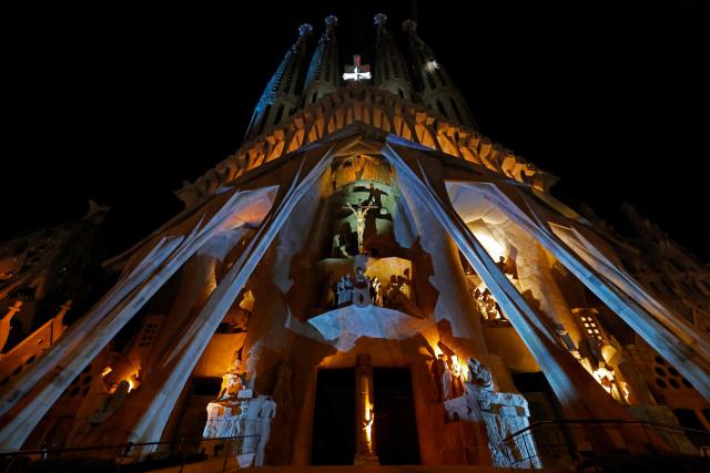 Lights illuminate the Passion facade (western side) of the Sagrada Familia basilica, during a music and light show narrating the passion and death of Jesus Christ, in Barcelona, on March 29, 2026, marking the start of the Holy Week. (Photo by Lluis GENE / AFP)