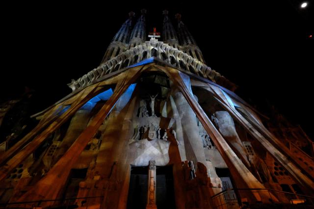 Lights illuminate the Passion facade (western side) of the Sagrada Familia basilica, during a music and light show narrating the passion and death of Jesus Christ, in Barcelona, on March 29, 2026, marking the start of the Holy Week. (Photo by Lluis GENE / AFP)