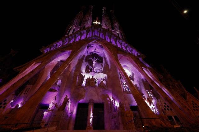 Lights illuminate the Passion facade (western side) of the Sagrada Familia basilica, during a music and light show narrating the passion and death of Jesus Christ, in Barcelona, on March 29, 2026, marking the start of the Holy Week. (Photo by Lluis GENE / AFP)