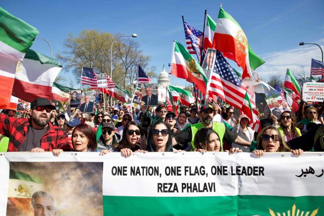 Demonstrators wave Iranian pre-1979 Islamic Revolution and US flags and hold images of Reza Pahlavi, son of the last shah of Iran, as they march during a rally in support of Iranians' fight for freedom, near the US Capitol in Washington, DC, on March 29, 2026. The event, organized by DCProtests4Iran, brought together members of the Iranian diaspora from the Washington, DC metropolitan area and surrounding states. (Photo by Amid FARAHI / AFP)