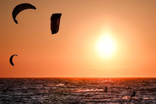Kitesurfers surf as the sun sets in Marseille, south-eastern France on March 29, 2026. (Photo by Thibaud MORITZ / AFP)