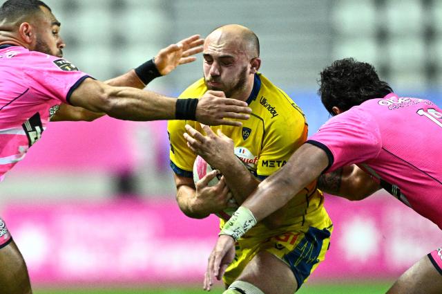 Clermont's French flanker Anthime Hemery (C) is tackled by Stade Français' English center Joe Marchant (L) and Stade Français' French center Tani Vili (R) during the French Top14 rugby union match between Stade Francais Paris and ASM Clermont Auvergne at the Jean-Bouin Stadium in Paris on March 29, 2026. 11, 12 (Photo by JULIEN DE ROSA / AFP)