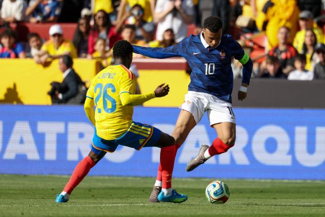 France's forward #10 Kylian Mbappe is challenged by Colombia's forward #26 Andres Gomez during a friendly football match between Colombia and France at Northwest Stadium in Landover, Maryland, on March 29, 2026. (Photo by FRANCK FIFE / AFP)