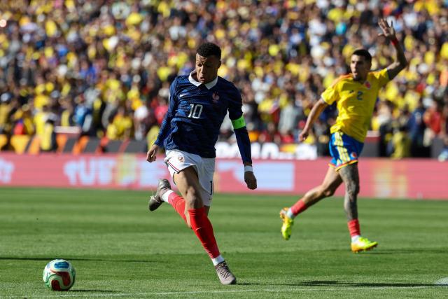 France's forward #10 Kylian Mbappe controls the ball as Colombia's defender #02 Daniel Munoz signals for an offside play during a friendly football match between Colombia and France at Northwest Stadium in Landover, Maryland, on March 29, 2026. (Photo by FRANCK FIFE / AFP)