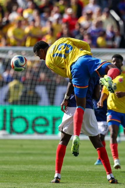 Colombia's defender #13 Juan Cabal jumps on France's forward #09 Marcus Thuram to head the ball during a friendly football match between Colombia and France at Northwest Stadium in Landover, Maryland, on March 29, 2026. (Photo by FRANCK FIFE / AFP)