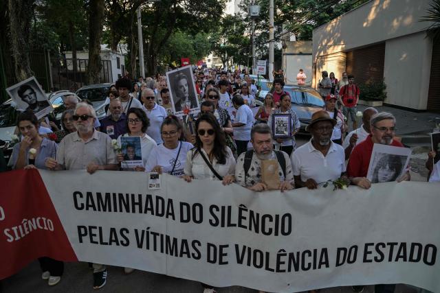 Relatives and social activists attend a silent march in memory of the victims of state violence during the 1964 dictatorship in Sao Paulo, Brazil on March 29, 2026. (Photo by NELSON ALMEIDA / AFP)