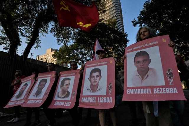Relatives and social activists attend a silent march in memory of the victims of state violence during the 1964 dictatorship in Sao Paulo, Brazil on March 29, 2026. (Photo by NELSON ALMEIDA / AFP)
