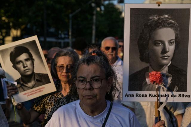 Relatives and social activists attend a silent march in memory of the victims of state violence during the 1964 dictatorship in Sao Paulo, Brazil on March 29, 2026. (Photo by NELSON ALMEIDA / AFP)