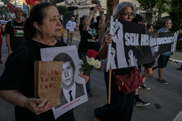 Relatives and social activists attend a silent march in memory of the victims of state violence during the 1964 dictatorship in Sao Paulo, Brazil on March 29, 2026. (Photo by NELSON ALMEIDA / AFP)