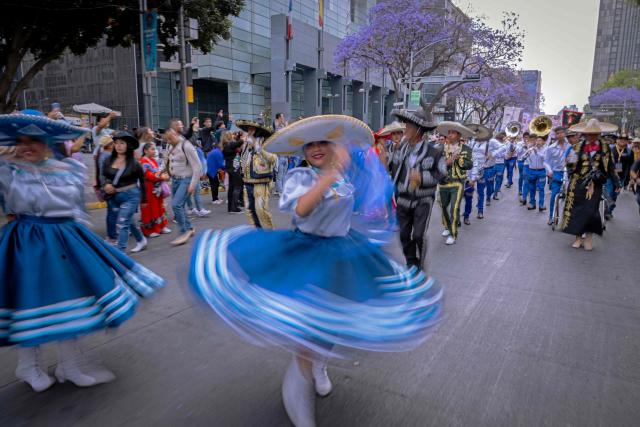 People take part in the annual spring carnival parade in Mexico City on March 29, 2026. (Photo by Carl de Souza / AFP)