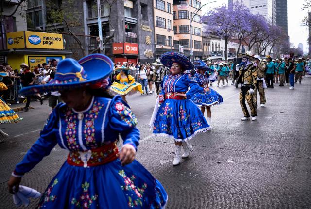Women take part in the annual spring carnival parade in Mexico City on March 29, 2026. (Photo by Carl de Souza / AFP)