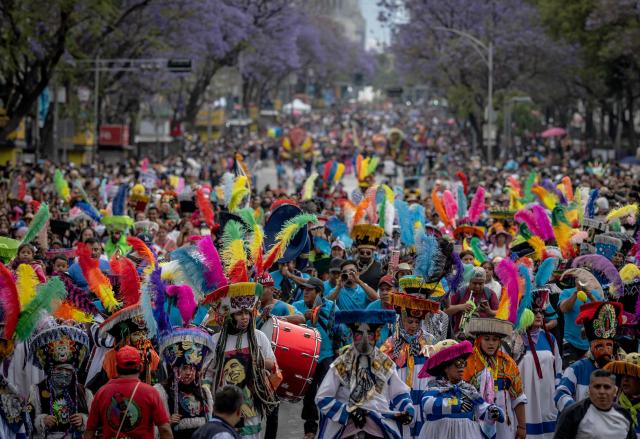 People take part in the annual spring carnival parade in Mexico City on March 29, 2026. (Photo by Carl de Souza / AFP)