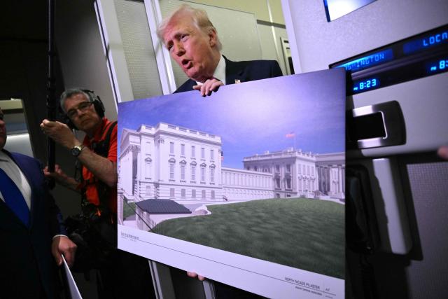Donald Trump holds a rendering of the East Wing modernization as he speaks to reporters aboard Air Force One en route to Joint Base Andrews, Maryland, on March 29, 2026. US President Donald Trump is returning to White House after spending the weekend at his Mar-A-Lago residence. (Photo by Mandel NGAN / AFP)