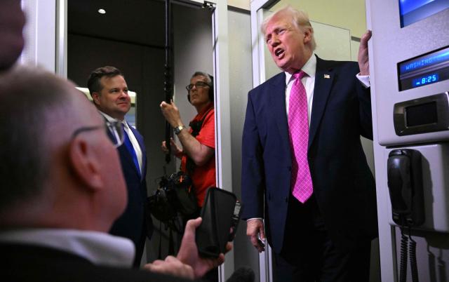 Donald Trump speaks to reporters aboard Air Force One en route to Joint Base Andrews, Maryland, on March 29, 2026. US President Donald Trump is returning to White House after spending the weekend at his Mar-A-Lago residence. (Photo by Mandel NGAN / AFP)