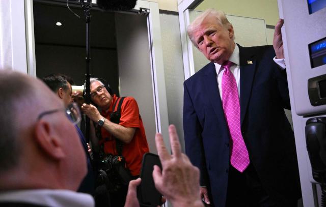 Donald Trump speaks to reporters aboard Air Force One en route to Joint Base Andrews, Maryland, on March 29, 2026. US President Donald Trump is returning to White House after spending the weekend at his Mar-A-Lago residence. (Photo by Mandel NGAN / AFP)