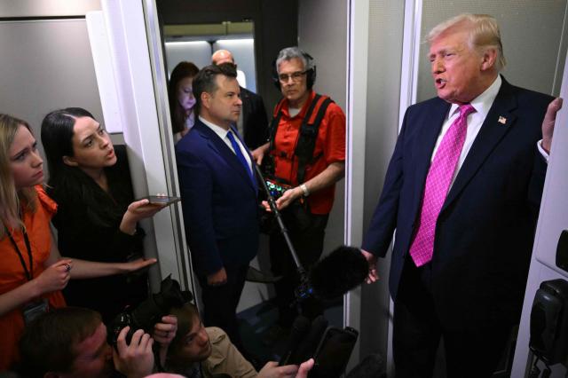 Donald Trump speaks to reporters aboard Air Force One en route to Joint Base Andrews, Maryland, on March 29, 2026. US President Donald Trump is returning to White House after spending the weekend at his Mar-A-Lago residence. (Photo by Mandel NGAN / AFP)