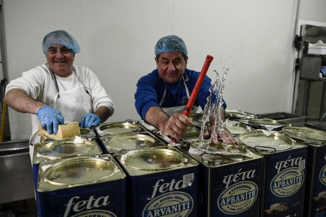 Employees work in a feta factory in Thessaloniki on February 19, 2026. From August 2024 to early March 2026, more than 480,000 sheep and goats have been slaughtered because of the pandemic, mainly in central and northern Greece. Producers say the resulting fall in the livestock population and milk production is threatening feta, one of Greece's premier exports. (Photo by Sakis Mitrolidis / AFP)