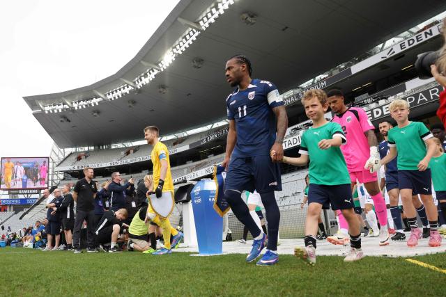 Cape Verde's Garry Rodrigues (R) leads his team out during the international friendly football match between Cape Verde and Finland at Eden Park in Auckland on March 30, 2026. (Photo by Michael Bradley / AFP)