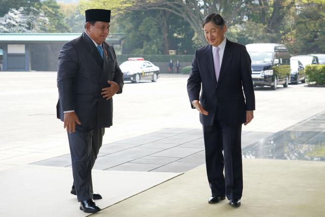 Indonesia's President Prabowo Subianto (L) is greeted by Japan's Emperor Naruhito at the Imperial Palace in Tokyo on March 30, 2026. (Photo by Kazuhiro NOGI / AFP)
