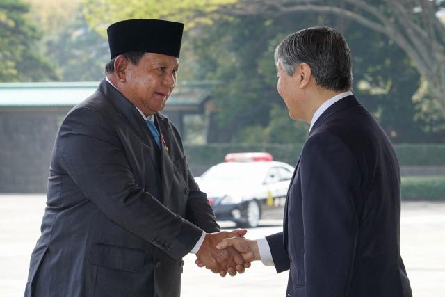 Indonesia's President Prabowo Subianto (L) is greeted by Japan's Emperor Naruhito at the Imperial Palace in Tokyo on March 30, 2026. (Photo by Kazuhiro NOGI / AFP)