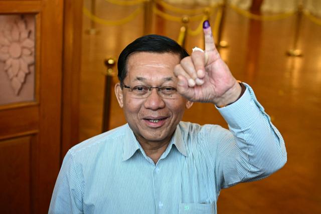 (FILES) Myanmar's junta chief Min Aung Hlaing shows his inked finger after voting at a polling station during the first phase of Myanmar's general election in Naypyidaw on December 28, 2025. A lawmaker in Myanmar nominated junta chief Min Aung Hlaing as a candidate for vice-president, a television broadcast on March 30, 2026 showed, paving the way for the coup leader to continue his rule in civilian garb. (Photo by Sai Aung MAIN / AFP)